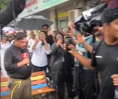 A press scrum in the rain