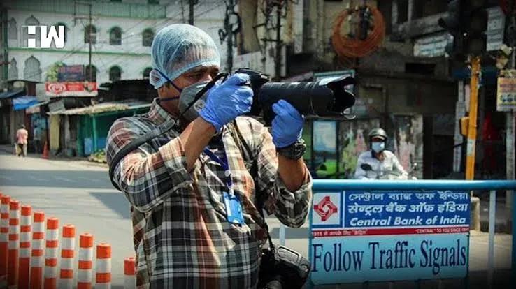 A cameraman filming on the street